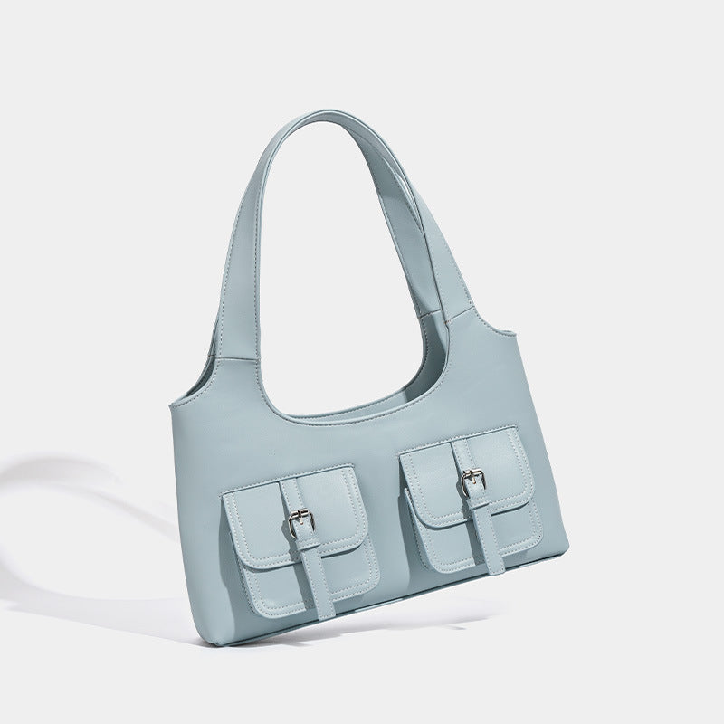Powder blue structured tote bag with dual front flap buckle pockets and silver-tone hardware, detail view 2