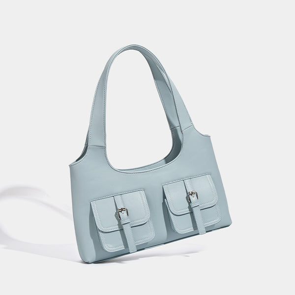 Powder blue structured tote bag with dual front flap buckle pockets and silver-tone hardware, detail view 2