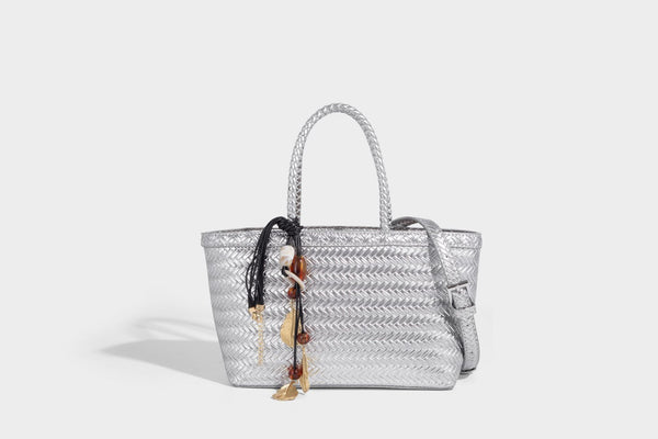 Structured chevron woven leather-look tote bag with braided top handles, gold feather charm, and adjustable shoulder strap