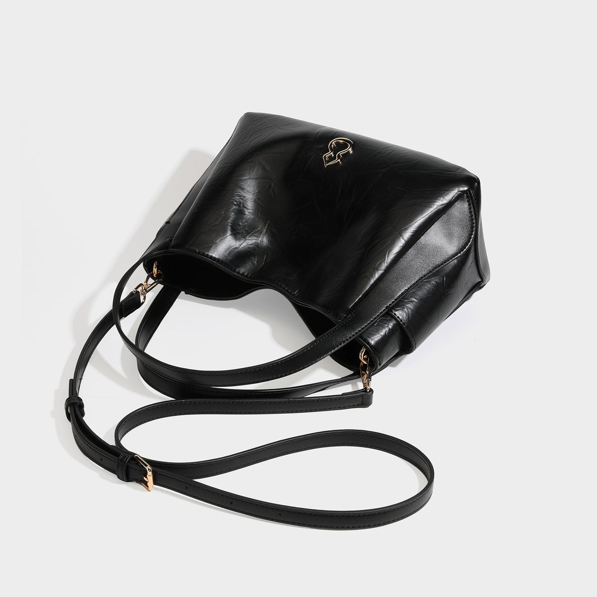 Black glossy crinkled leather-look convertible shoulder tote bag with gold gourd-shaped emblem hardware and detachable