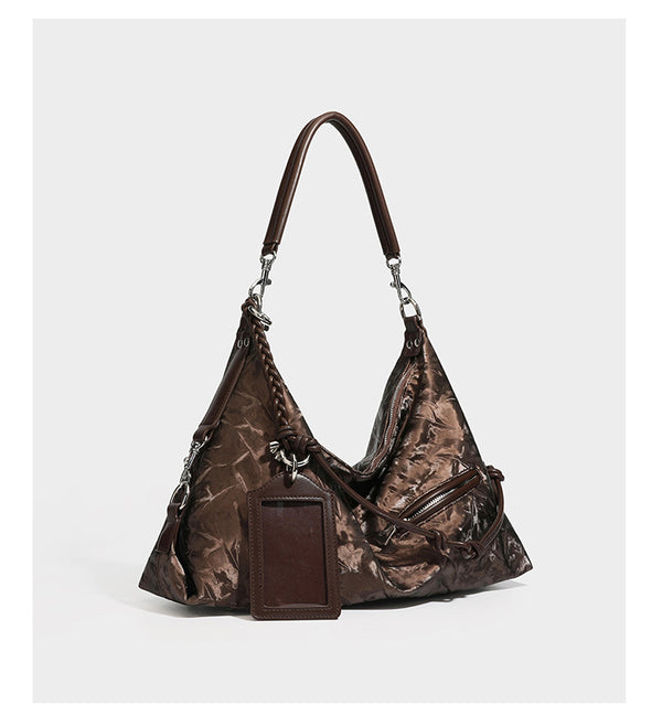 Slouchy hobo shoulder bag in crinkled metallic brown leather-look finish with braided rope knots, silver-tone hardware