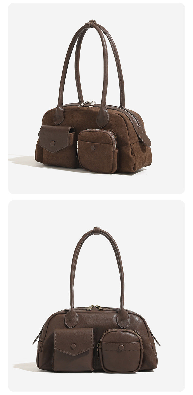 Structured retro bowling-style top-handle handbag with dual zip closure, front snap-flap pocket, and front zip pocket, detail