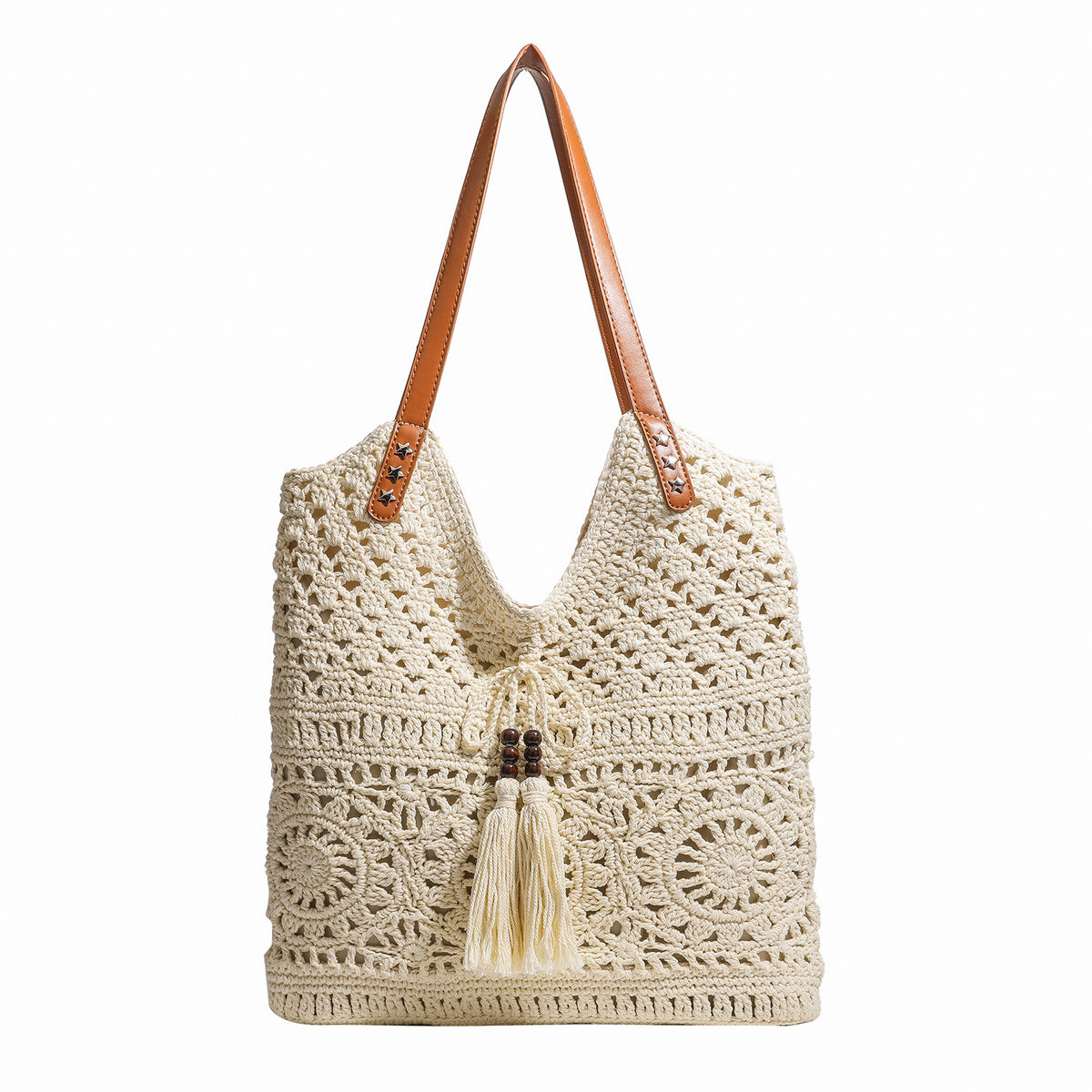 Cream openwork crochet tote bag with tan leather-look double shoulder straps and tassel drawstring tie, detail view 5