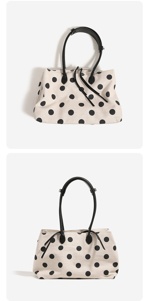 Cream canvas tote bag with black polka dots, rounded leather-look handles, and zip-top closure, detail view 10