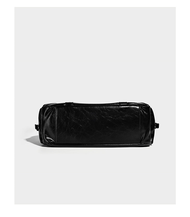 Glossy structured black tote shoulder bag with silver buckle hardware, zip pockets, dual top handles, and detachable, detail