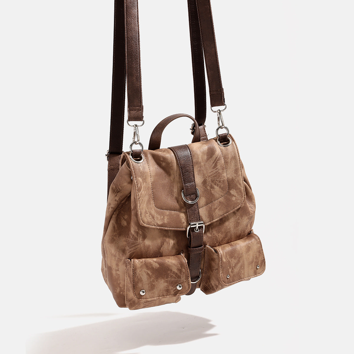 Compact distressed leather-look tan-brown backpack handbag with flap-and-buckle closure, two front patch pockets, top handle