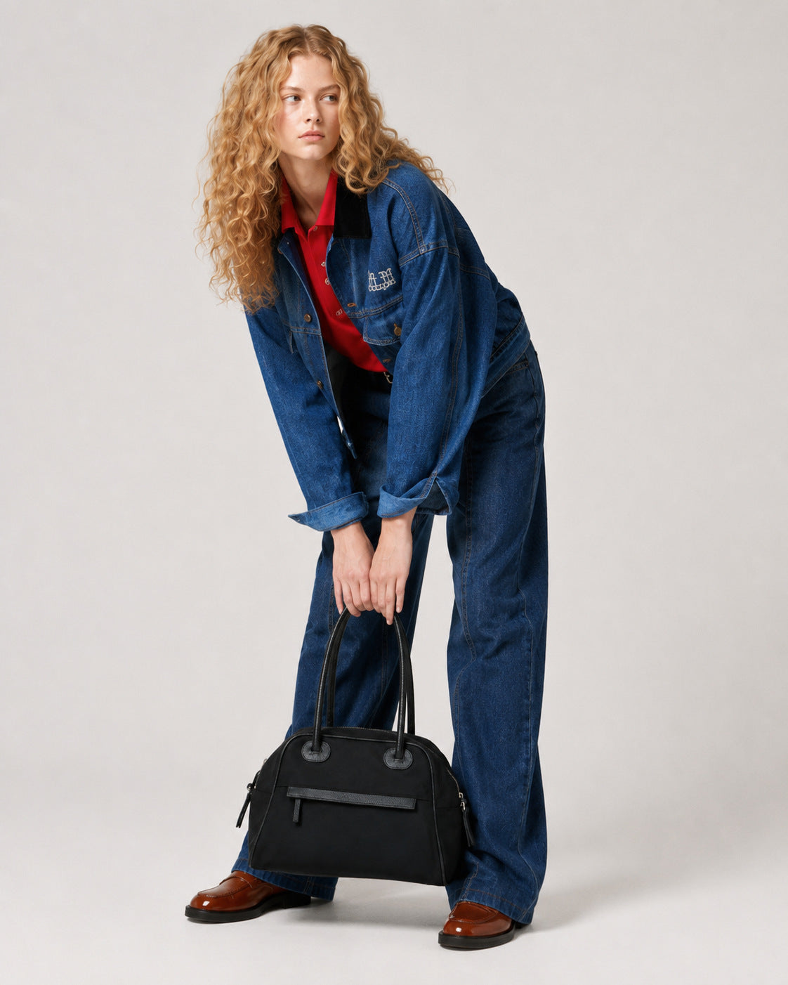 Structured dome top-handle bag in matte nylon with pebbled vegan leather-look trim, zip-top closure, front slip pocket, and