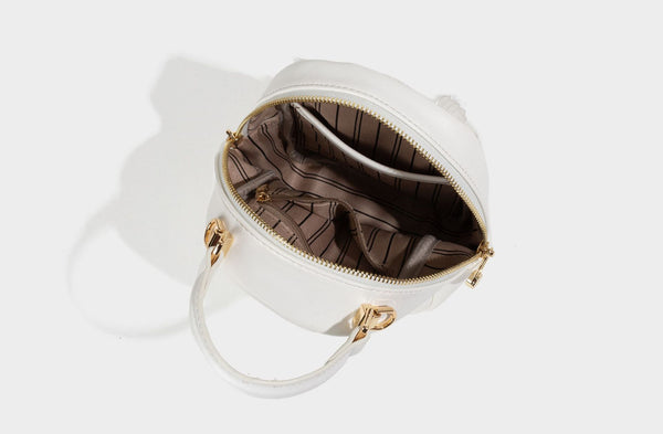 Structured mini backpack handbag with butterfly embroidery, gold-tone chain strap, and turn-lock front flap pocket, detail