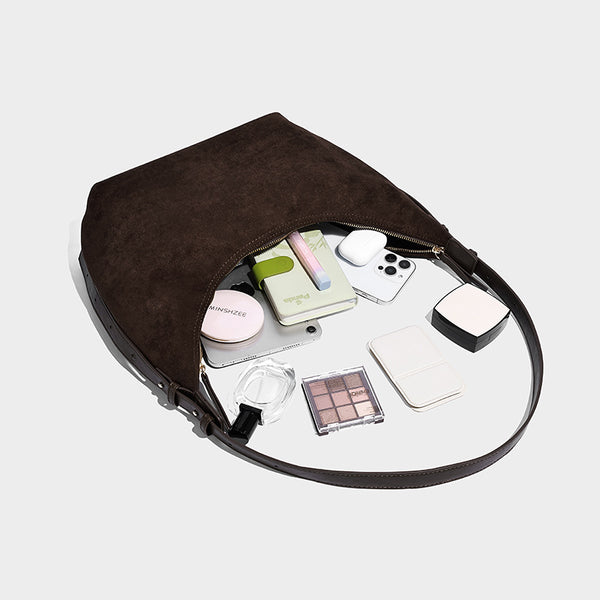 Slouchy crescent hobo shoulder bag in dark chocolate matte suede-look finish with adjustable strap and twin-pull top zip