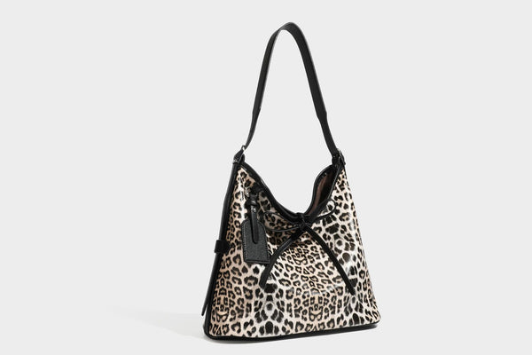 Slouchy leopard print shoulder hobo bag with black leather-look trim, tie-top closure, and single long strap, detail view 29