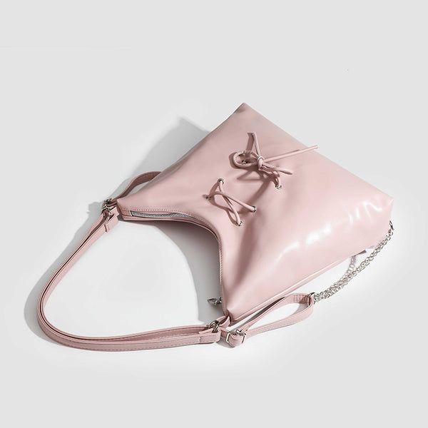 Glossy leather-look hobo shoulder bag with front bow lacing detail and silver-tone chain strap, detail view 4