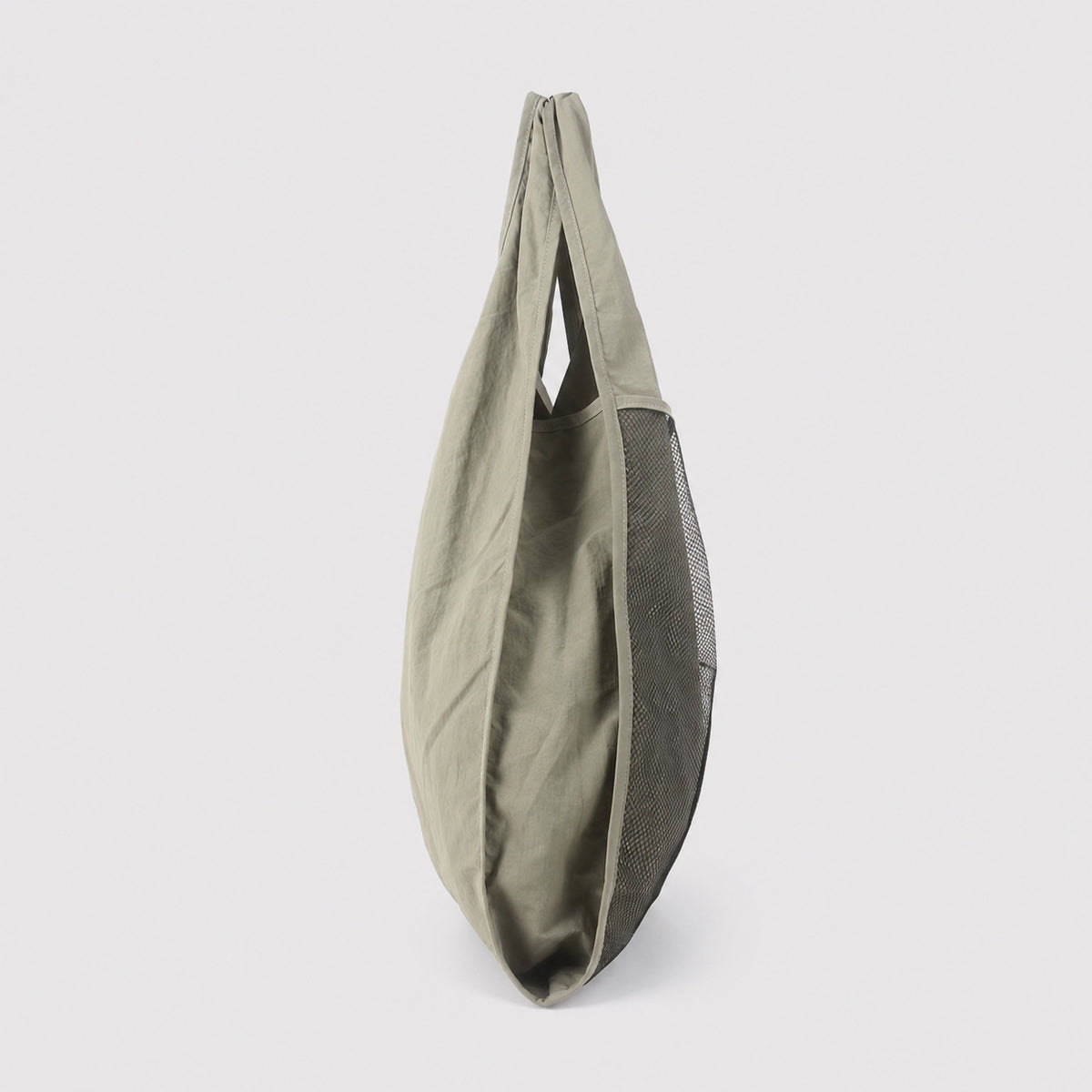 Oversized triangular mesh tote bag with matte olive-khaki fabric straps and trim, dark open-weave mesh body, matte black