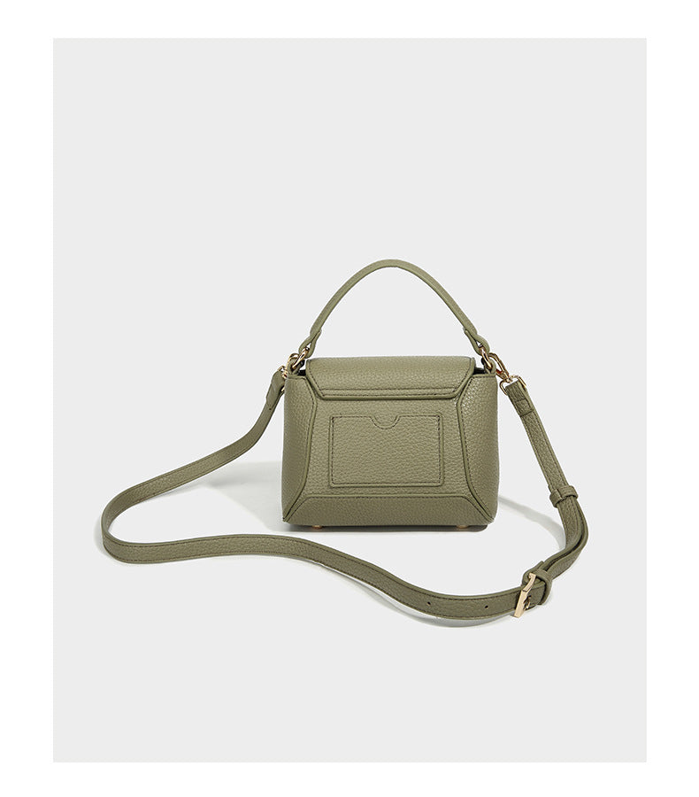 Small structured pebbled flap mini satchel with gold-tone bar hardware, short top handle, and detachable crossbody strap