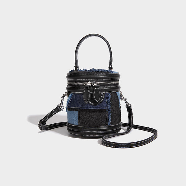 Mini cylindrical barrel bucket bag in denim patchwork with frayed edges, smooth leather-look trim, zip-around top closure