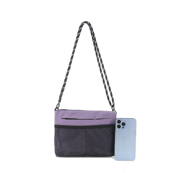 Flat rectangular crossbody bag with mesh front pocket, top zip closure, and adjustable patterned strap, detail view 16