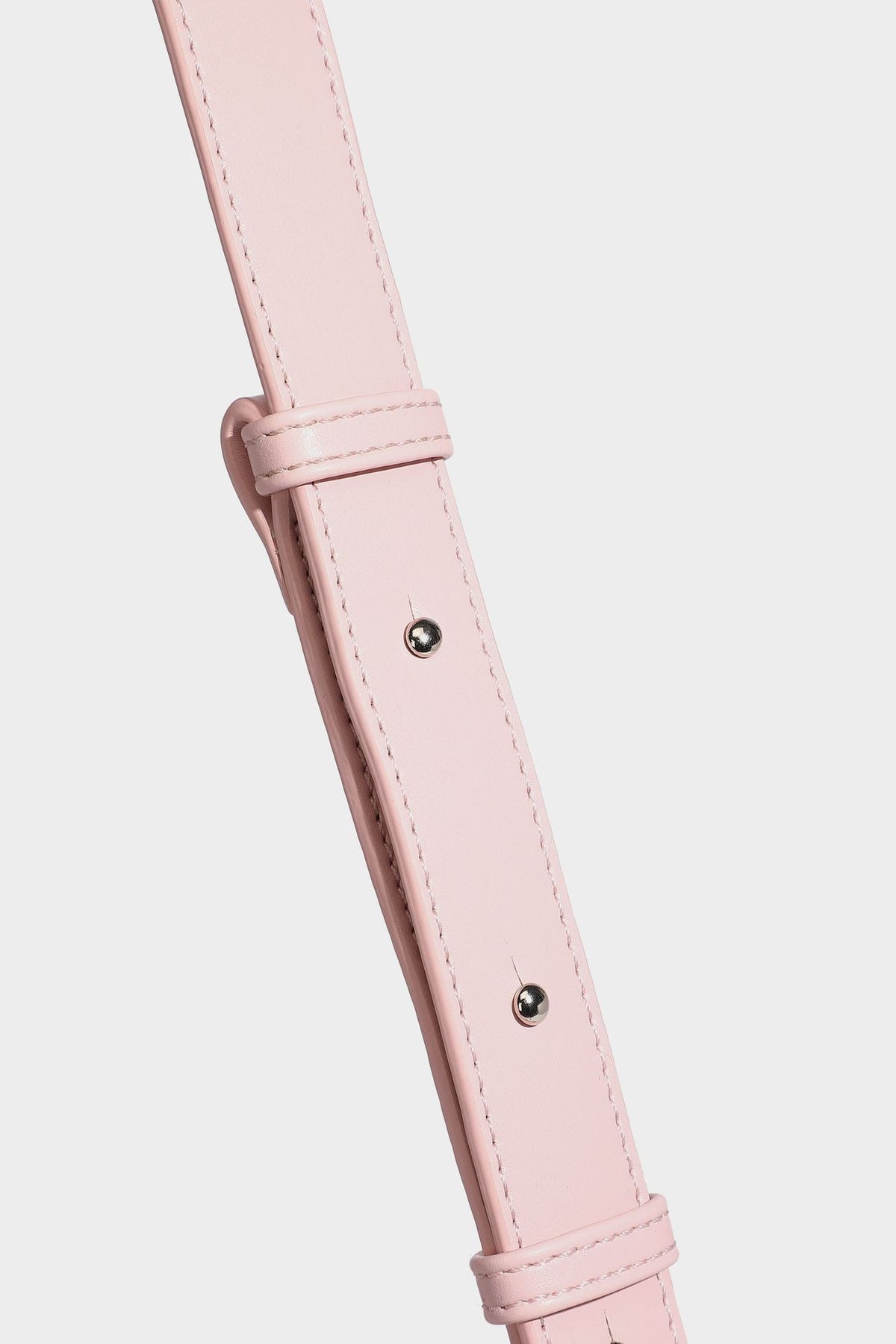 Smooth leather-look crescent shoulder bag with front zip pocket, side flap pockets, adjustable strap, and silver-tone, detail