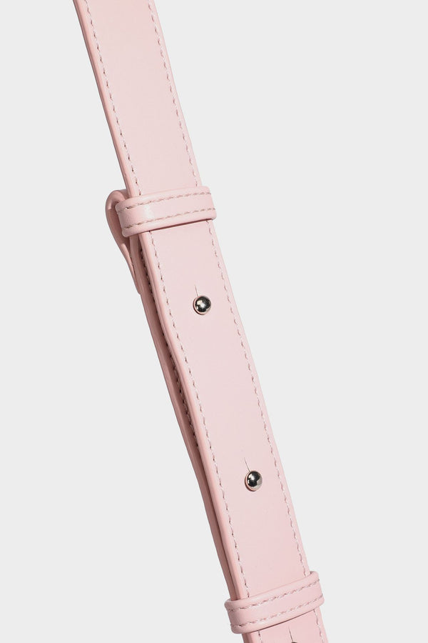 Smooth leather-look crescent shoulder bag with front zip pocket, side flap pockets, adjustable strap, and silver-tone, detail