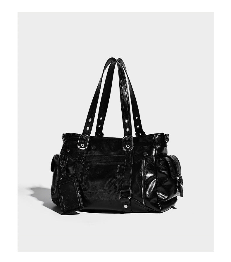 Glossy structured black tote shoulder bag with silver buckle hardware, zip pockets, dual top handles, and detachable, detail