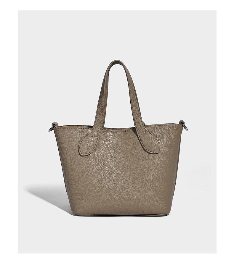 Compact pebbled bucket tote bag with elephant charm, twin top handles, and detachable crossbody strap, detail view 11