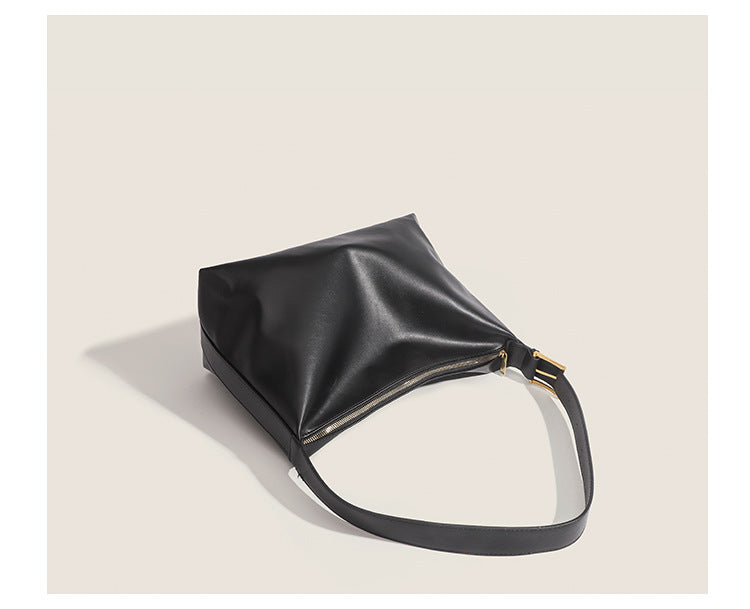 Large slouchy hobo shoulder bag in smooth leather-look finish with single long strap and gold-tone zip closure, detail view