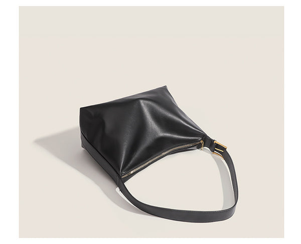 Large slouchy hobo shoulder bag in smooth leather-look finish with single long strap and gold-tone zip closure, detail view