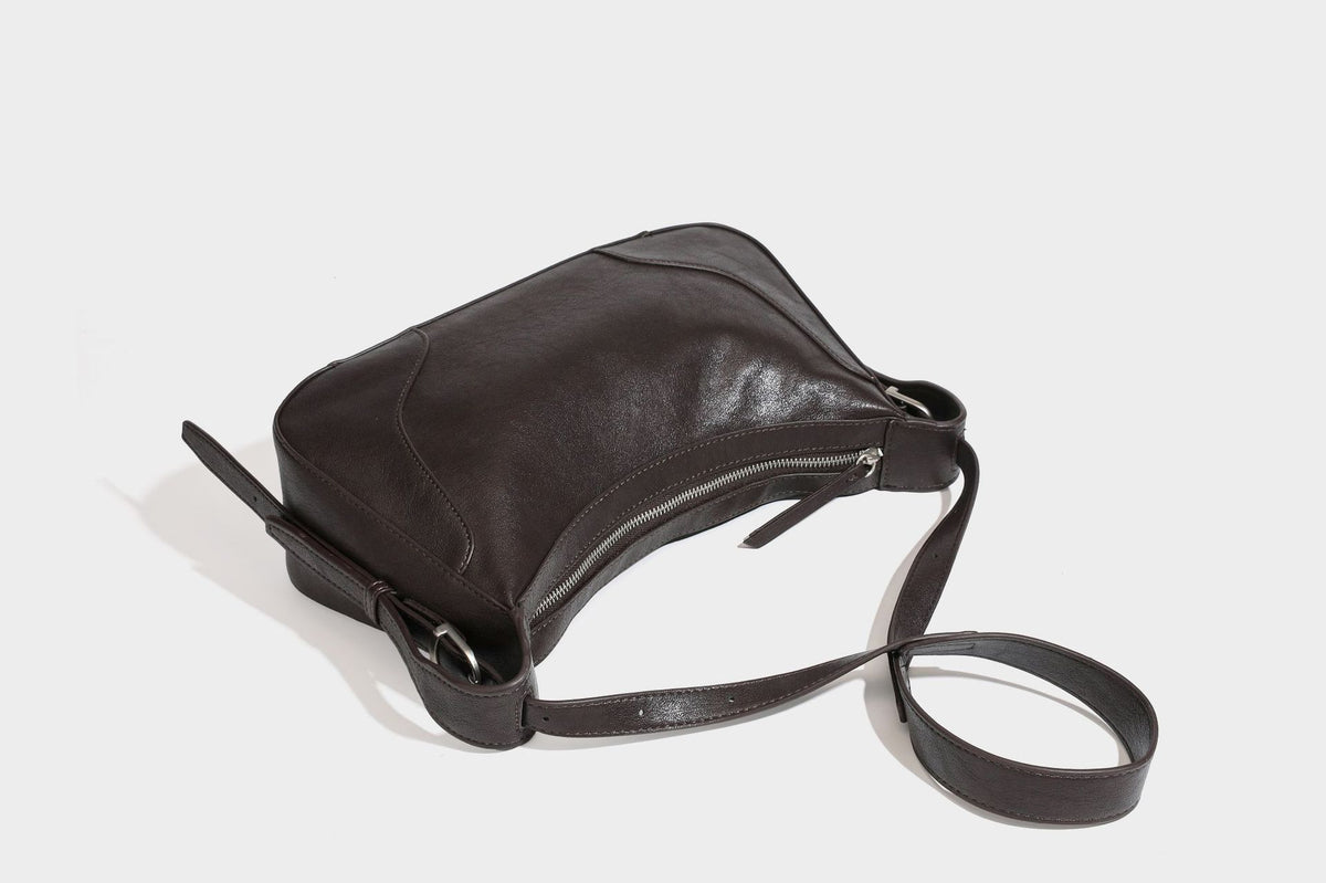 Slouchy crescent hobo shoulder bag in dark brown pebbled leather-look finish with zip top and long shoulder strap, detail