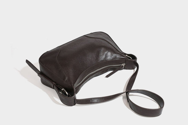 Slouchy crescent hobo shoulder bag in dark brown pebbled leather-look finish with zip top and long shoulder strap, detail