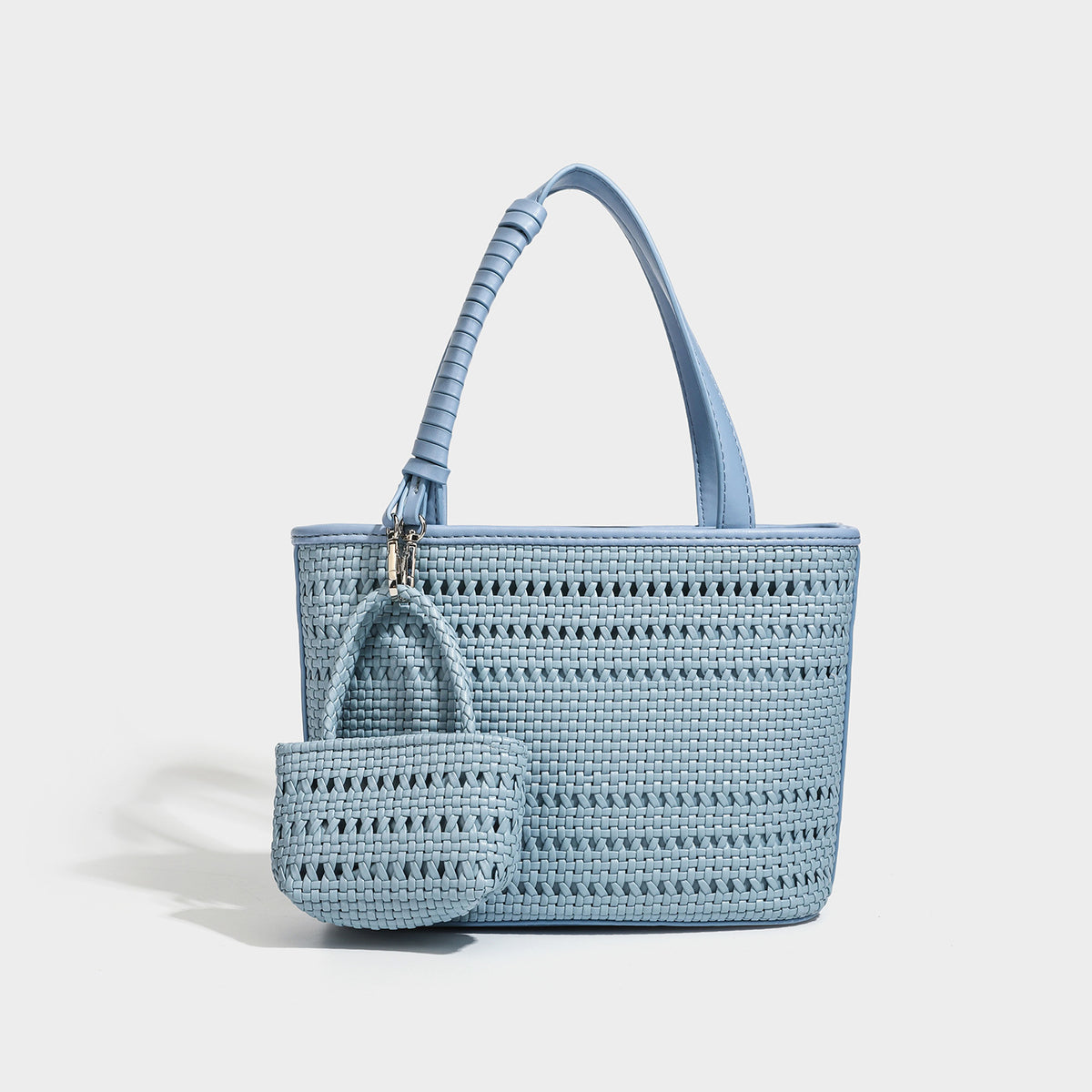 Structured open-weave tote bag with smooth leather-look trim, double top handles, detachable crossbody strap, and mini zip