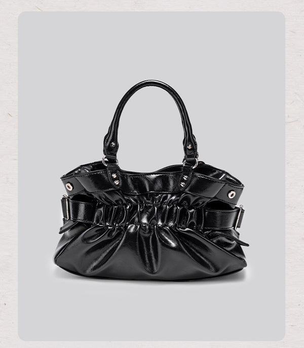 Black glossy ruched convertible tote bag with silver-tone rivets, detachable wide shoulder strap, external zip pouch, and