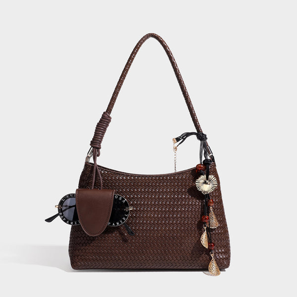 Woven-texture hobo shoulder bag in brown with braided top handle, adjustable crossbody strap, front flap pocket, and, detail