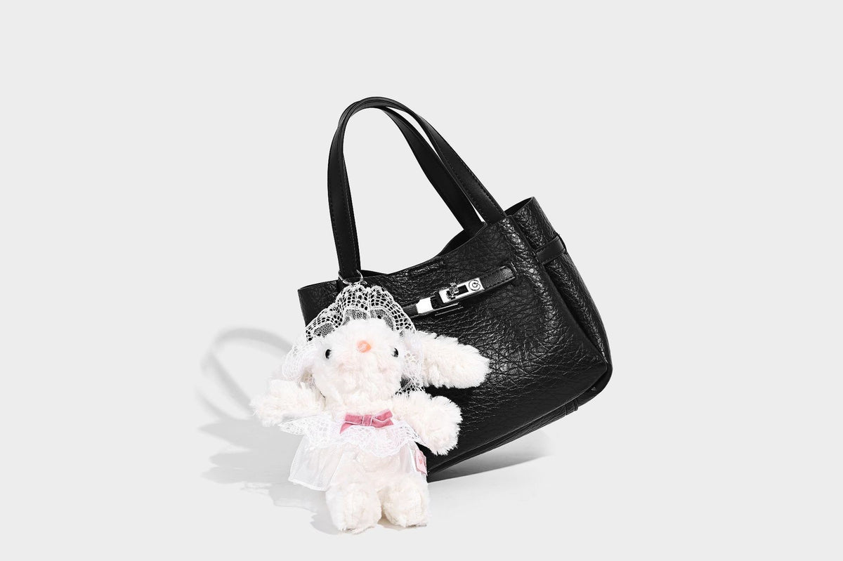 Small structured pebbled bucket tote with double top handles, silver turn-lock hardware, and detachable shoulder strap