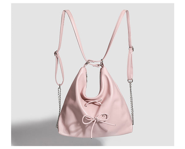 Glossy leather-look hobo shoulder bag with front bow lacing detail and silver-tone chain strap, detail view 18
