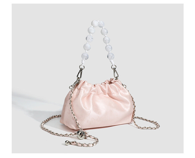 Small ruched drawstring pouch bag with pearl-bead handle and silver-tone chain strap, detail view 12