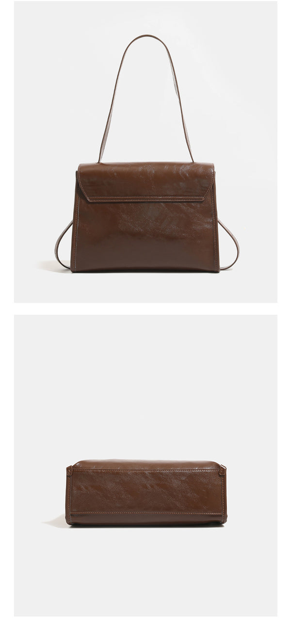 Structured rectangular flap shoulder bag in glossy leather-look finish with silver turn-lock clasp and adjustable strap