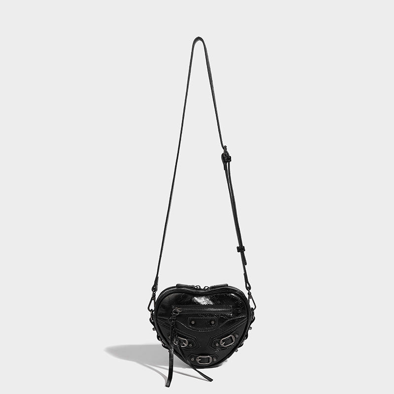 Mini heart-shaped crossbody bag with glossy crinkled finish and moto buckle hardware, detail view 17