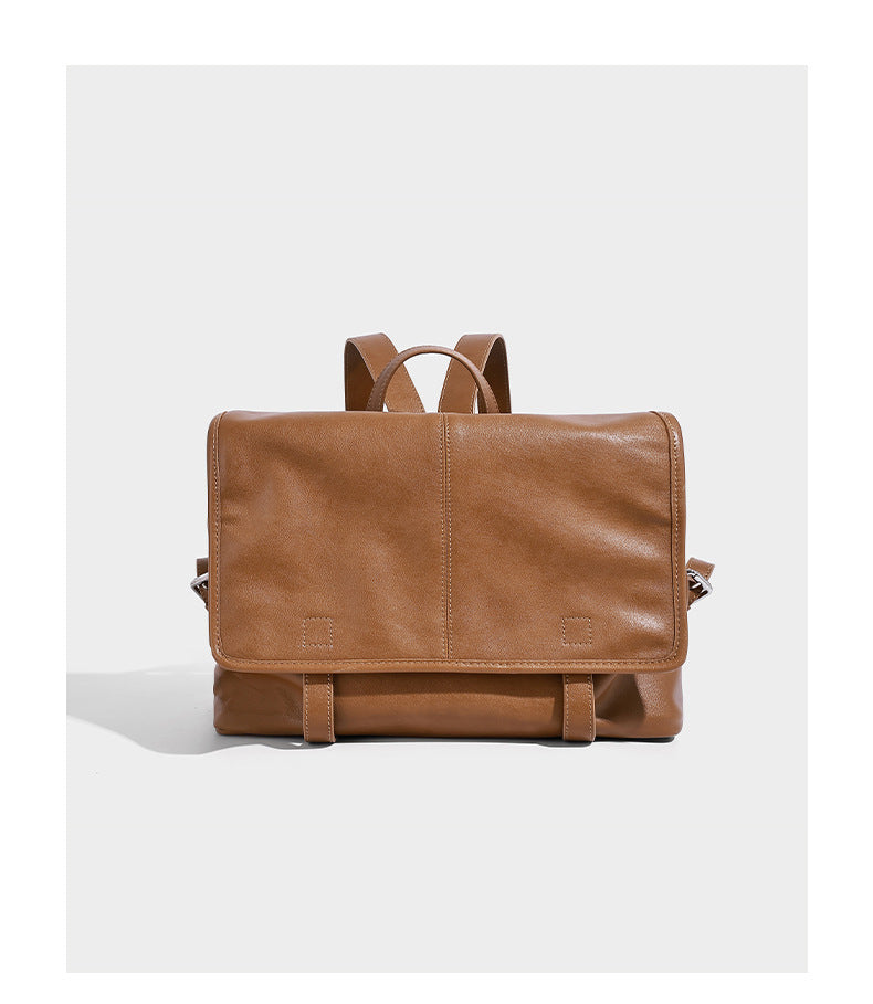 Structured tan leather-look flap backpack handbag with top handle, silver buckle hardware, and fold-over front closure