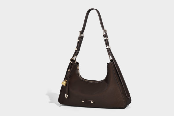 Crescent hobo shoulder bag in pebbled leather-look finish with top zipper, adjustable strap, gold-tone ring hardware, and