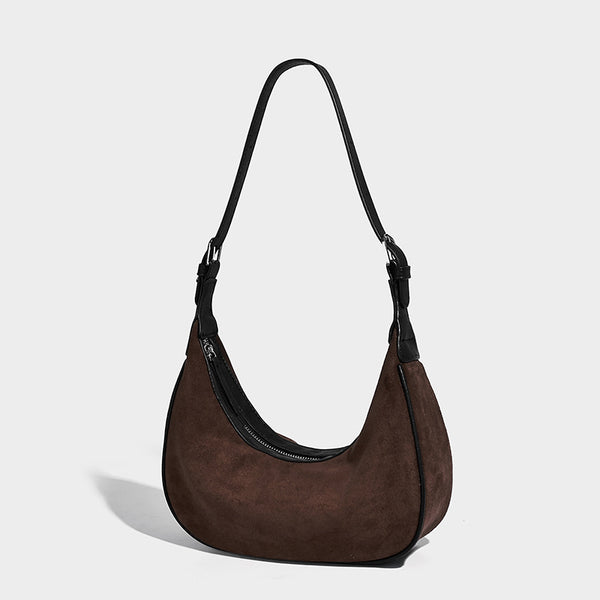 Crescent hobo shoulder bag in matte suede-look finish with black trim and adjustable strap, front view