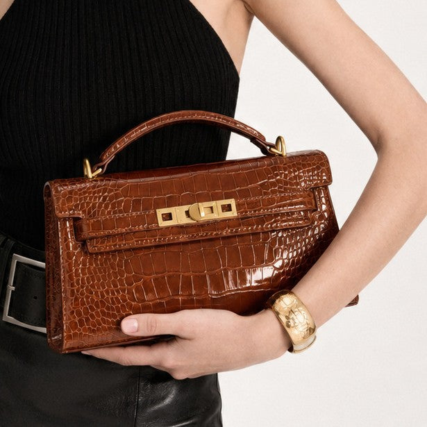 Structured croc-embossed rectangular satchel bag with gold turn-lock hardware and short top handle, detail view 4