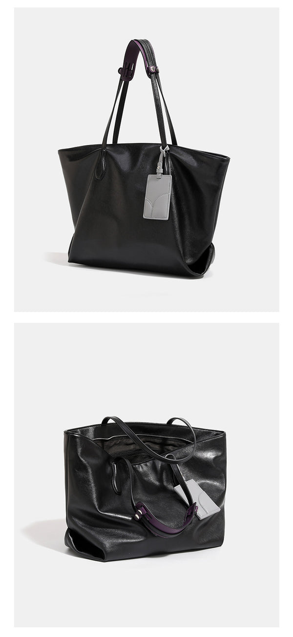 Large soft trapezoid tote bag with leather-look finish, dual shoulder straps, and gray hanging card tag, detail view 12