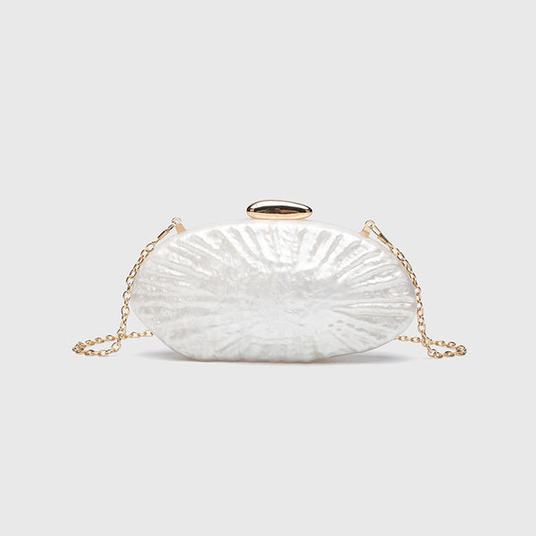 Oval pearl-finish shell clutch bag with gold-tone clasp and removable gold link chain strap, detail view 6