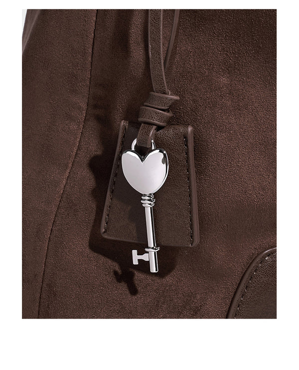 Dark brown slouchy hobo bag with matte suede-look body, smooth leather-look base trim, adjustable shoulder strap, and, detail