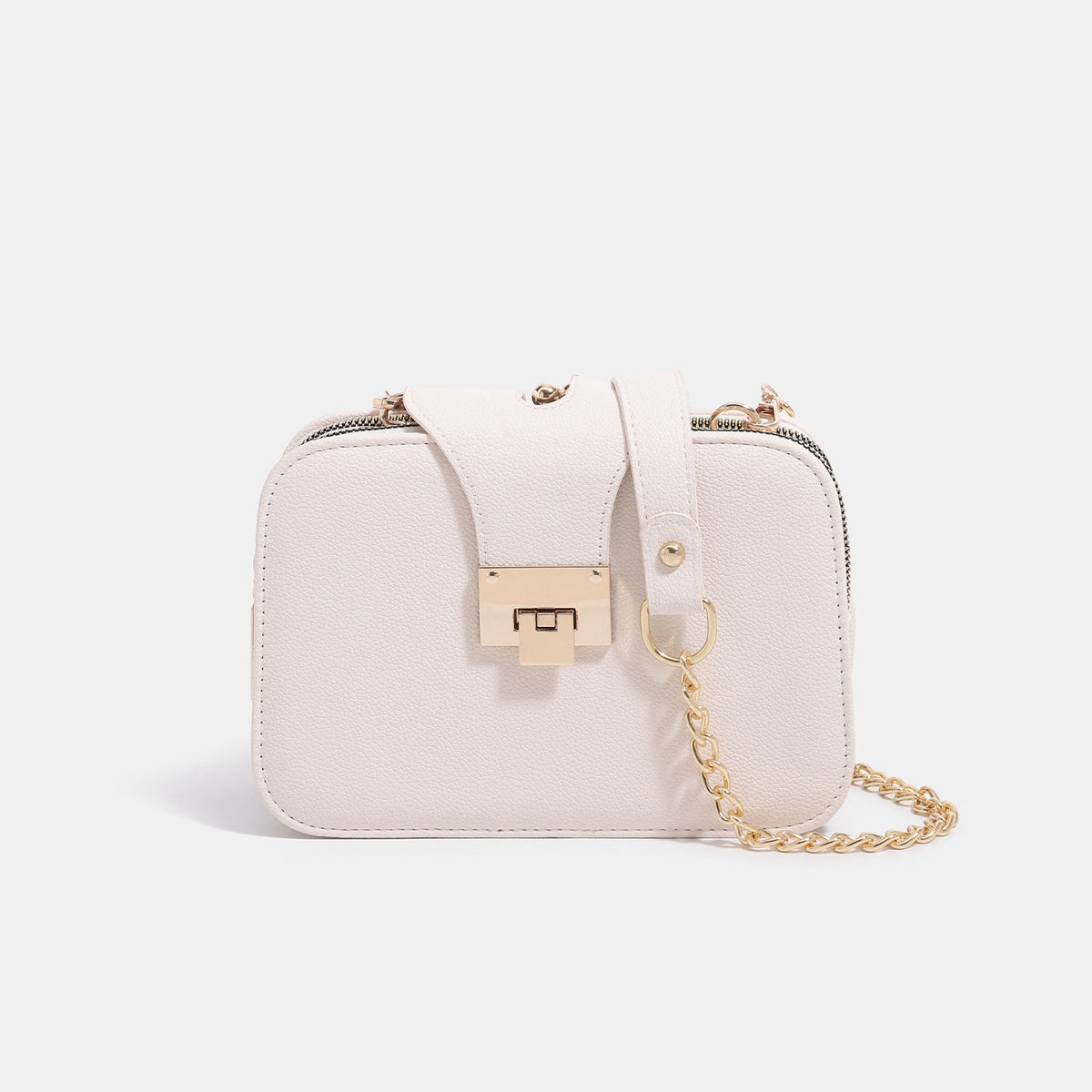 Small structured rectangular crossbody bag with pebbled finish, gold-tone turn-lock front flap, chain strap, and dual side