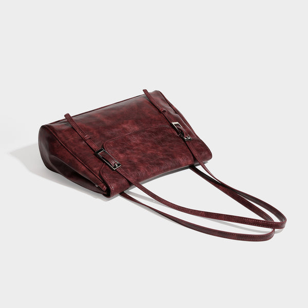 Structured flap-top shoulder tote bag in distressed leather-look finish with silver-tone buckle hardware and double shoulder