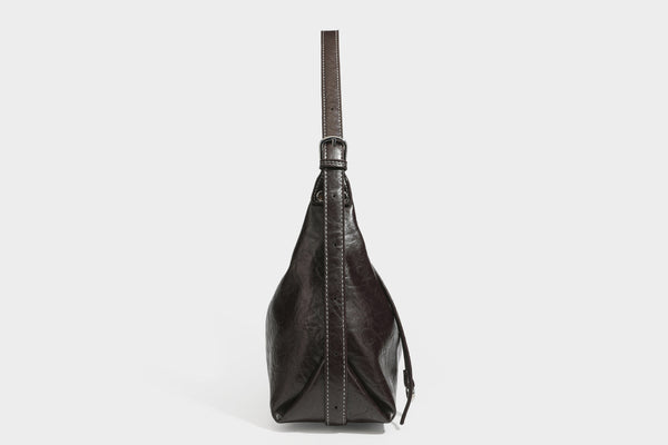 Slouchy hobo shoulder bag in glossy crinkled leather-look finish with zip-top closure and silver-tone ring hardware, detail