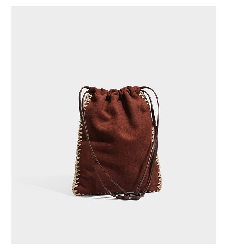 Matte suede-look drawstring bucket bag with cream braided woven edge trim and slim adjustable leather-look shoulder strap