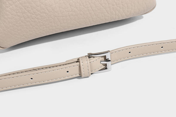 Small structured pebbled bucket tote with double top handles, silver turn-lock hardware, and detachable shoulder strap