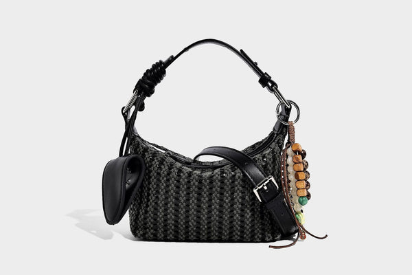 Woven crescent shoulder bag with leather-look knotted handle, zip top, attached mini pouch, and silver-tone hardware, detail
