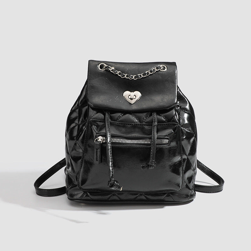 Quilted leather-look backpack with heart turn-lock clasp and woven chain handles, detail view 7