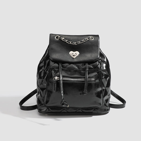 Quilted leather-look backpack with heart turn-lock clasp and woven chain handles, detail view 7